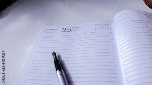 a notebook and a quill pen