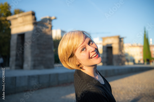 A woman enjoys traveling in Madrid Spain and visits the historic Templo de Debod (Temple of Debod), an Egyptian temple transported to Madrid for preservation.