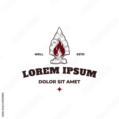 Stone spearhead with fire adventure logo design