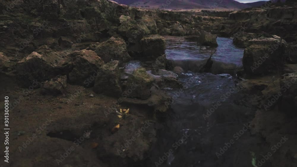 Canyon and a river passing through. Narrow steep rocky ravine. Natural landmark.