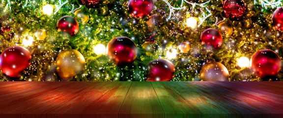 top wood desk with christmas tree and red ball hanging blur background,wooden table
