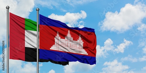 Tableau sur toile United Arab Emirates and Cambodia flag waving in the wind against white cloudy blue sky together