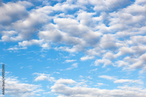 clouds of an average tier high cumulus  on a blue background of the sky