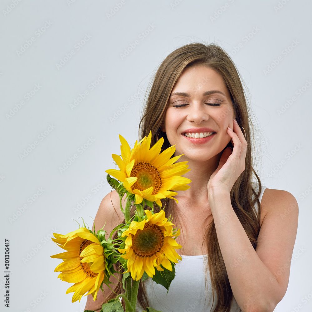 portrait of happy woman with closed eyes holding sunflowers . portrait of happy woman with closed eyes holding sunflowers .