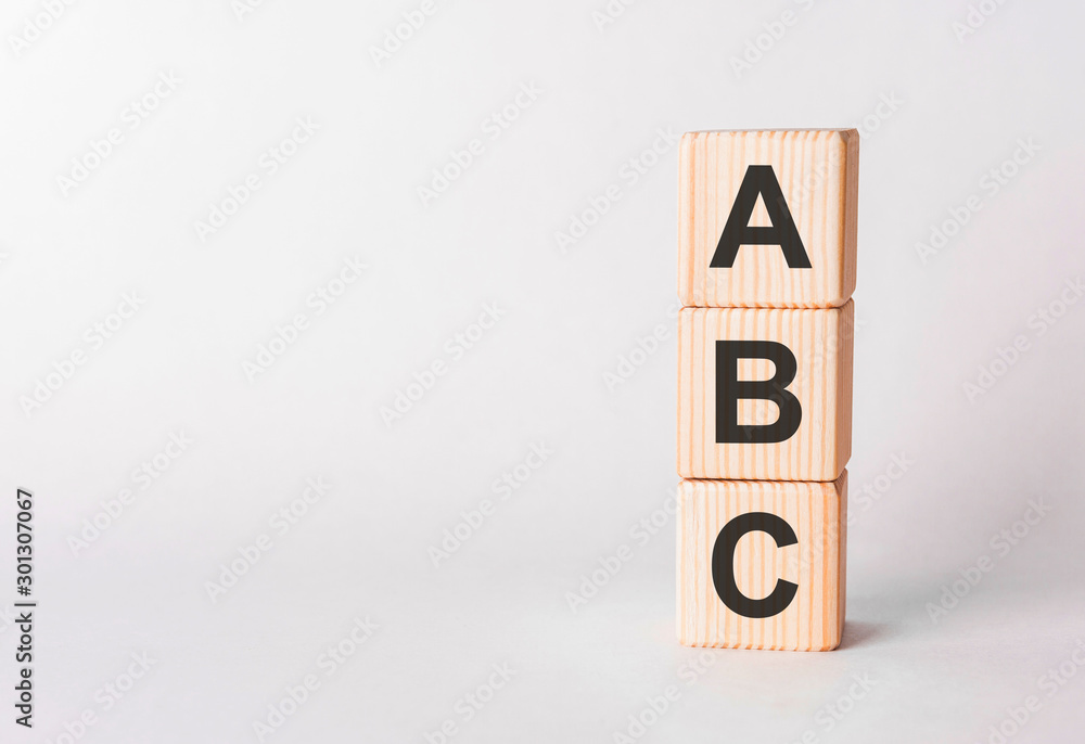 ABC letters of wooden blocks in pillar form on white background, copy space ABC letters of wooden blocks in pillar form on white background, copy space