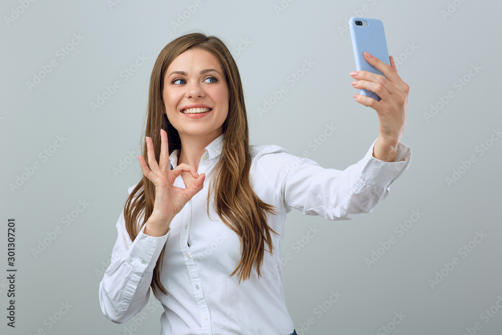 Happy woman with big toothy smile making selfie on smartphone. Happy woman with big toothy smile making selfie on smartphone.