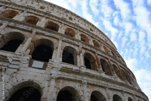 Close up view of Colosseum against blue sky in Rome, Italy. photo