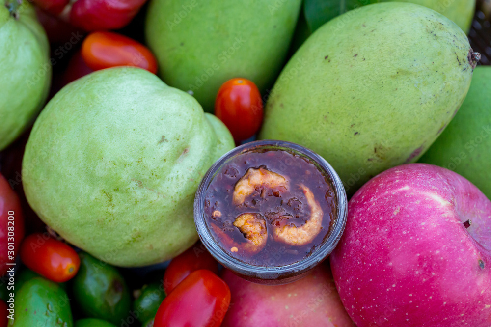 Raw mango slice with sweet dried shrimp sauce, Mango and Guava with sweet fish sauce is a delicious menu. Ancient thai food mango sweet fish sauce Street food in thailand