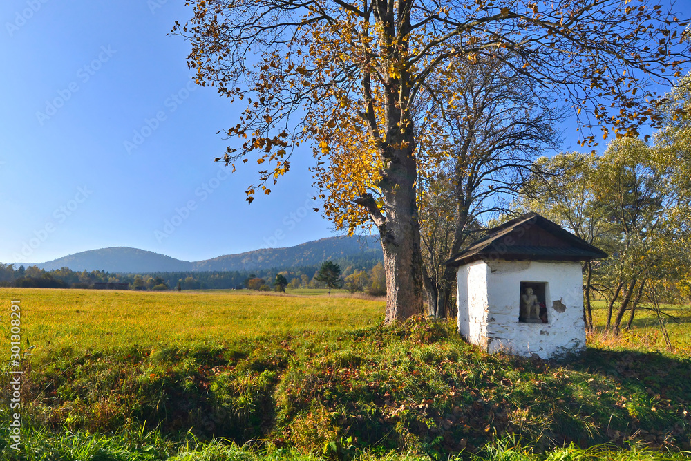 Old small chapel of Pensive Christ in autumn sunny day, Low Beskids (Beskid Niski), Poland.