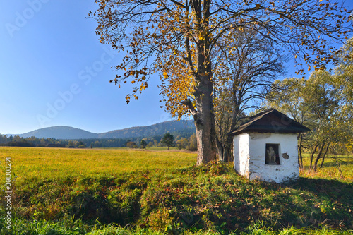 Old small chapel of Pensive Christ in autumn sunny day, Low Beskids (Beskid Niski), Poland.