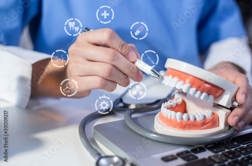 Professional doctor dentist holding dental with teeth icons, Health, dentistry concept.