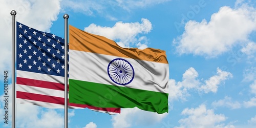 Bild auf Leinwand United States and India flag waving in the wind against white cloudy blue sky together