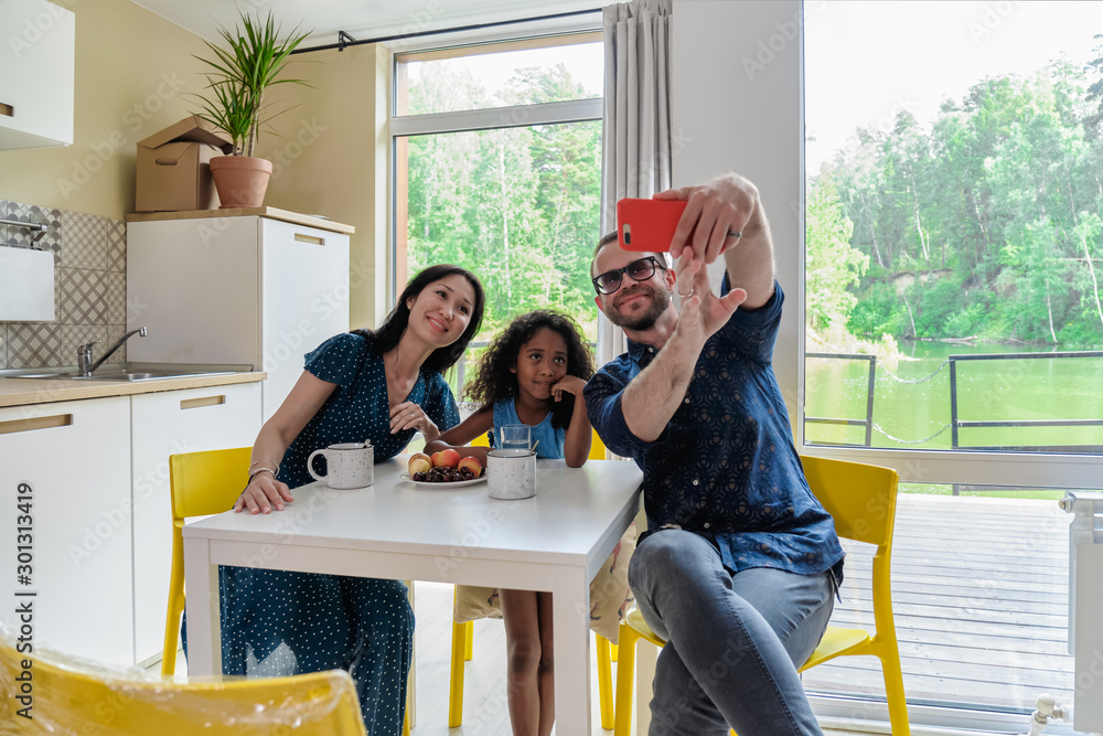 Happy mixed race family Family Group Move in Rent Real Estate. Positive Looking at Relocating or Unpacking of Carton Pack by Playful Dad Happy mixed race family Family Group Move in Rent Real Estate. Positive Looking at Relocating or Unpacking of Carton Pack by Playful Dad