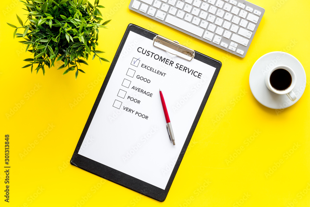 Customer service form on yellow office desk top view copy space Customer service form on yellow office desk top view copy space