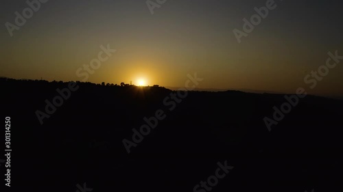 Wallpaper Mural Aerial drone footage of desert valley at dramatic sunset, deserted volcanic landscape, dry, golden yellow sun, black mountains silhouettes in Andalusia, Spain, 4K UHD. Fast slide tracking. Torontodigital.ca