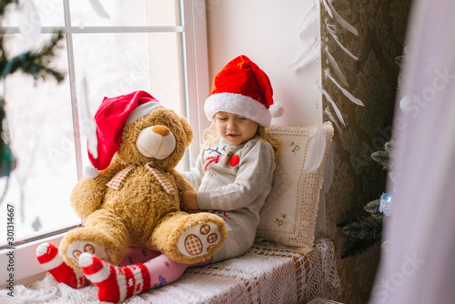 happy child girl sitting back in the winter window Christmas © sushytska