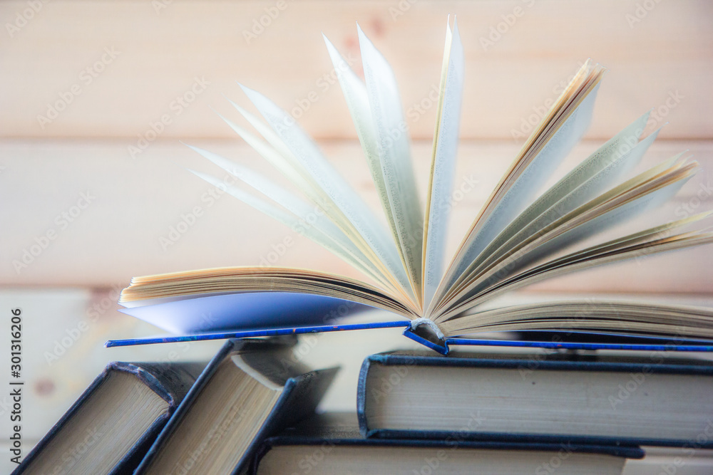Naklejka premium Stack of colorful books. Education background. Back to school. Book, hardback colorful books on wooden table. Education business concept. Copy space for text