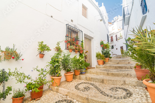 Quiet street of the town of Frigiliana, a traditional white village in the mountain of the coast of Malaga, Spain.
