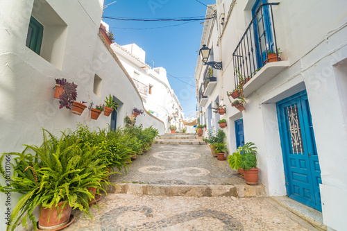 Quiet street of the town of Frigiliana, a traditional white village in the mountain of the coast of Malaga, Spain. photo