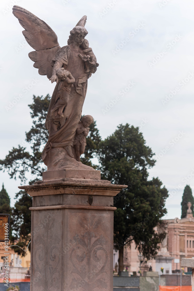 Christian Statue in the Day of Commemoration of the Dead in Italian Cemetery