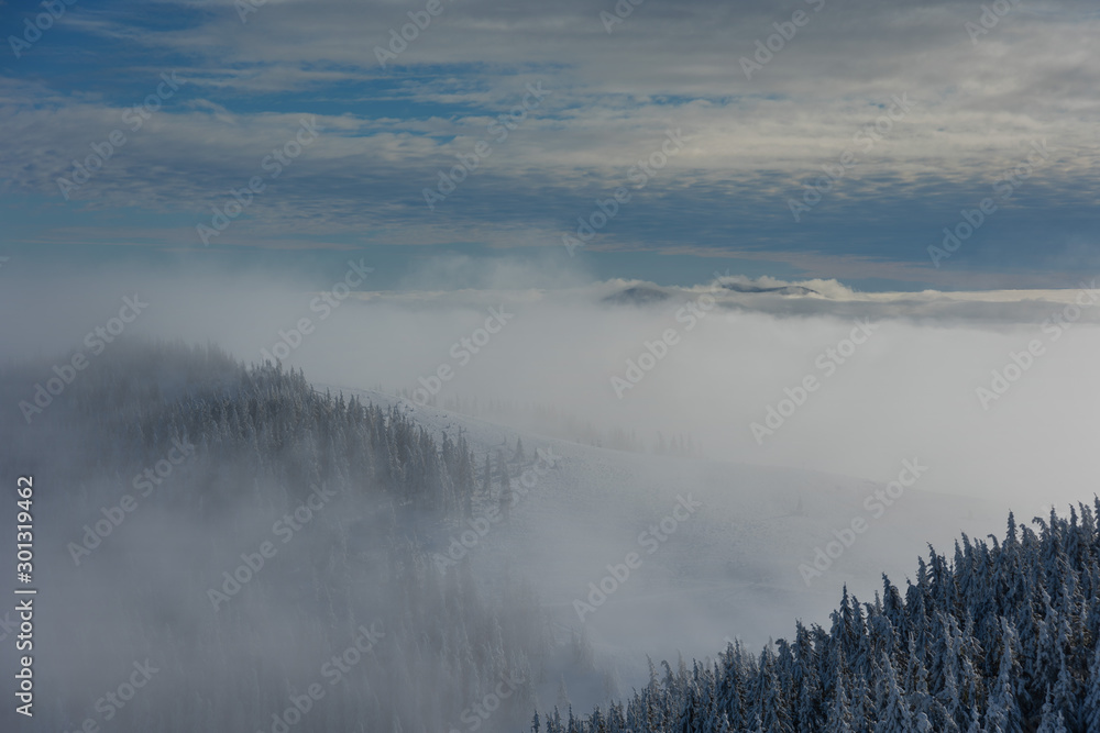Beautiful scenery with winter snow-capped mountains, with fogs and contrasting snow structure and red tourist tent in the foreground, in locations in the Ukrainian Carpathians. Beautiful scenery with winter snow-capped mountains, with fogs and contrasting snow structure and red tourist tent in the foreground, in locations in the Ukrainian Carpathians.
