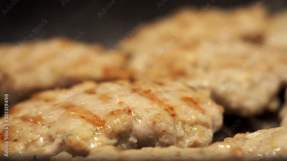 hot tasty juicy fried hamburger Patty with a crispy brown crust, lying on a pan grill with greasy olive oil. Slow motion close-up hot tasty juicy fried hamburger Patty with a crispy brown crust, lying on a pan grill with greasy olive oil. Slow motion close-up