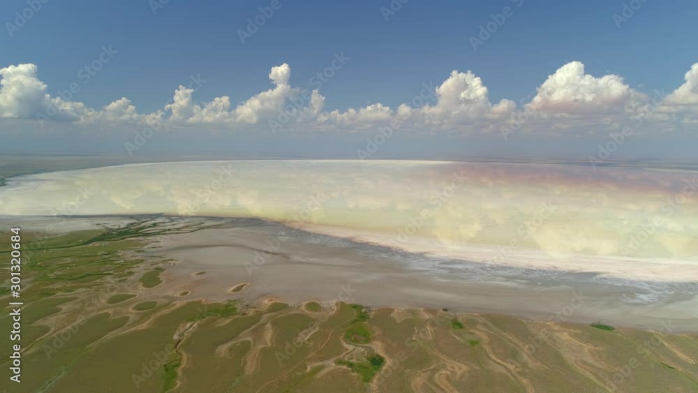 From great hight epic miracle nature landscape Russia salt lake Elton coastal river network pattern white pink mineral bottom brine endless expanse horizon Volga steppe sight. Divine clouds reflection From great hight epic miracle nature landscape Russia salt lake Elton coastal river network pattern white pink mineral bottom brine endless expanse horizon Volga steppe sight. Divine clouds reflection