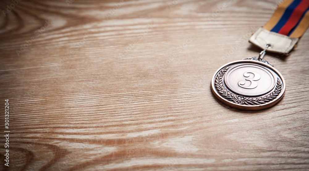 Medal awards for winner on wooden background. Medal awards for winner on wooden background.