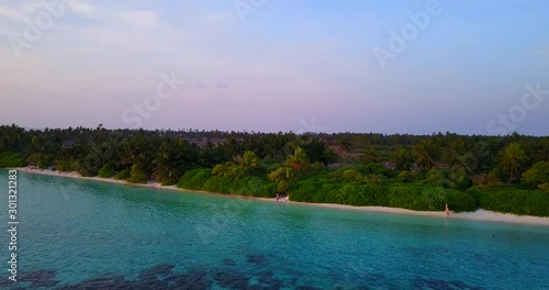 foamy waves splashing paradise white sand beach on caribbean tropical island with preserved nature. Palm forest and turquoise water on early morning photo