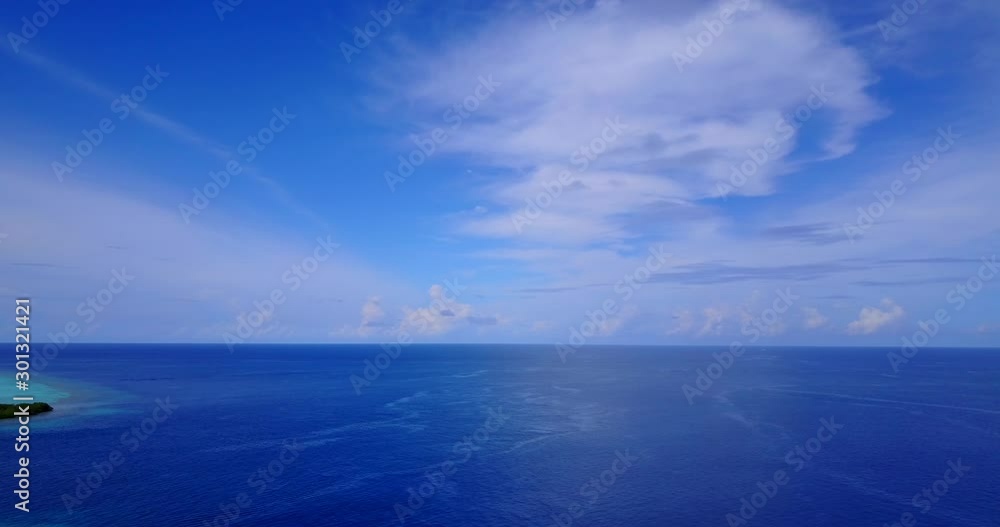 Open Blue Turquoise Tropical Ocean Under A Bright Blue Sky with clouds Open Blue Turquoise Tropical Ocean Under A Bright Blue Sky with clouds