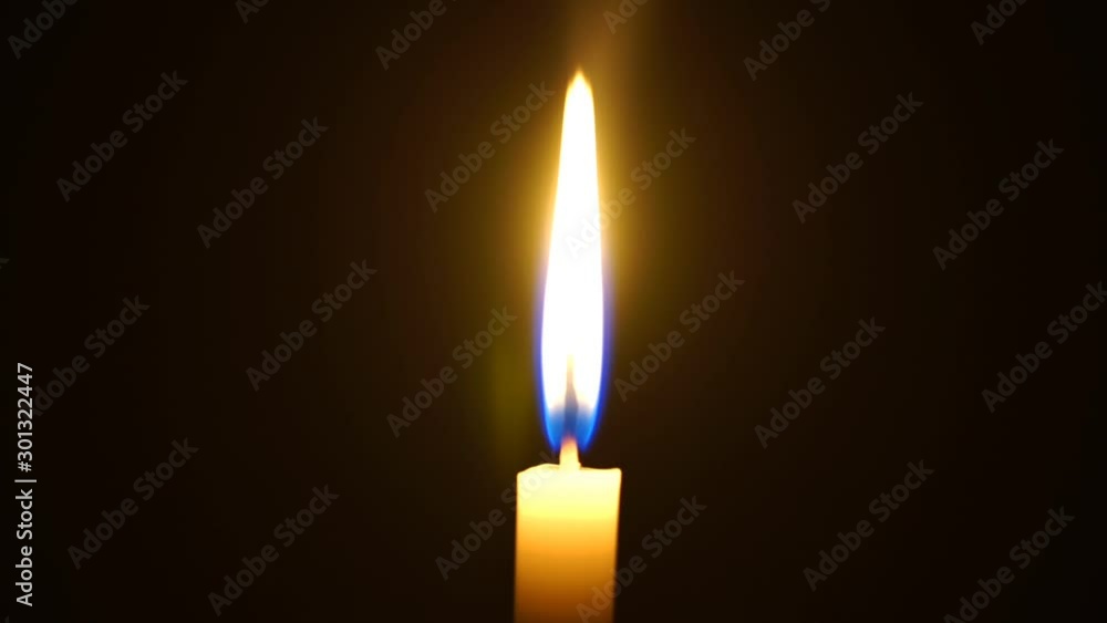 One candle light illuminated in a black background. One candle light illuminated in a black background.