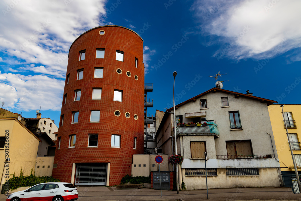 .Round house in the form of a tower of red brick.