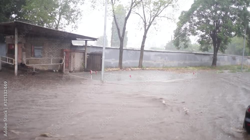 Natural cataclysm, flood. Flooding in the city.Car traffic on a flooded road in a rain downpour. Weather cataclysm flood. Lots of water, large puddles. Natural cataclysm, flood. Flooding in the city.Car traffic on a flooded road in a rain downpour. Weather cataclysm flood. Lots of water, large puddles.