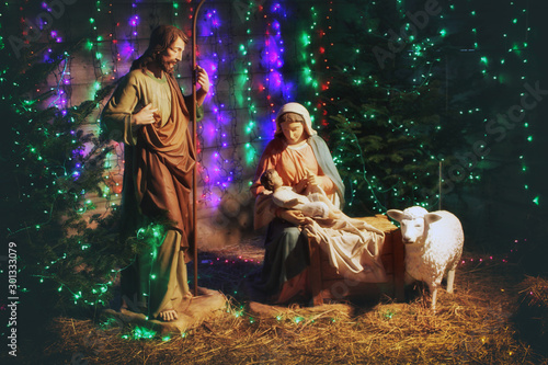 Obraz na plátně Christmas Manger scene with figures including Jesus, Mary, Joseph, sheep and magi
