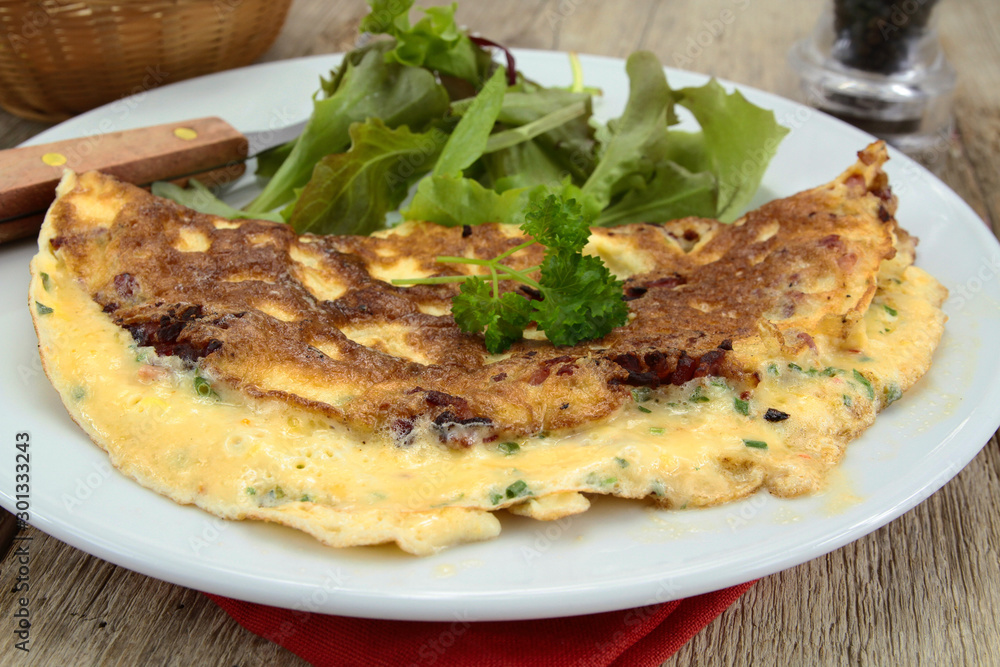 herbed omelette and bacon on a plate