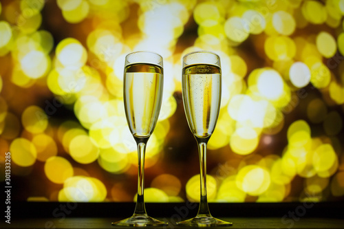 Two glasses of champagne on a bokeh background. Close-up isolated background.