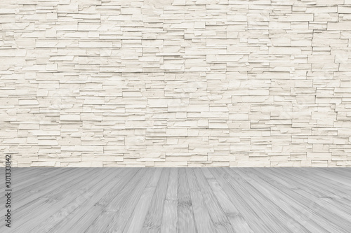 Stone tile wall limestone rock background in light beige color tone with grey wooden floor 