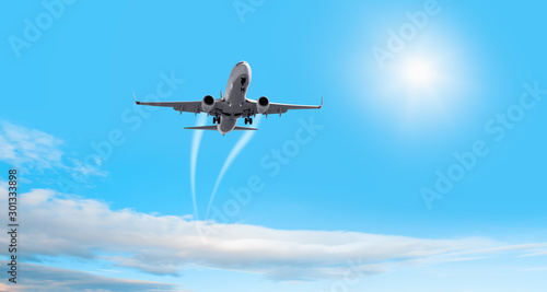 Fototapeta Naklejka Na Ścianę i Meble -  White passenger airplane in the clouds - Travel by air transport