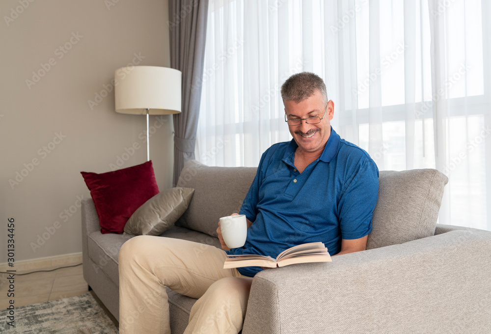 middle aged man reading a book