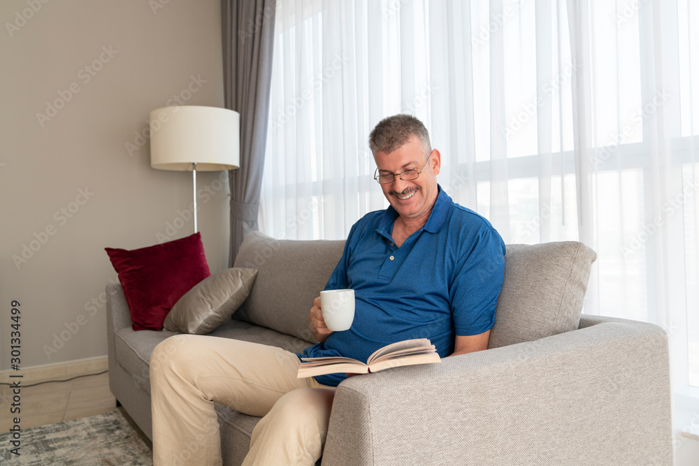 middle aged man reading a book middle aged man reading a book