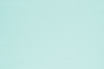 Authentic fine Thai silk fabric textile detailed texture background in light green blue color