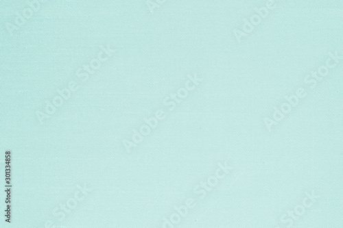 Authentic fine Thai silk fabric textile detailed texture background in light green blue color
