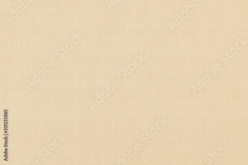 Fabric cloth background wallpaper texture pattern in sepia pastel yellow creme beige color tone