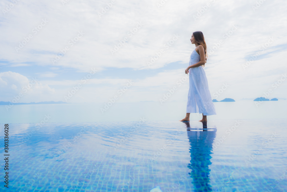 Portrait young asian woman relax smile happy around swimming pool in hotel and resort Portrait young asian woman relax smile happy around swimming pool in hotel and resort