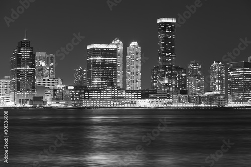 Black and white picture of Jersey City skyline at night, USA.
