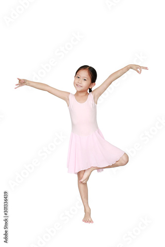 Beautiful little Asian child girl in pink tutu skirt isolated on white background. Children is studying ballet.