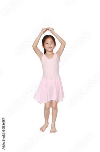 Beautiful little Asian child girl in pink tutu skirt dancing over white background. Children is studying ballet.
