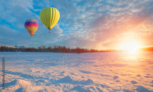 Hot air balloon in the sky in winter at amazing sunset