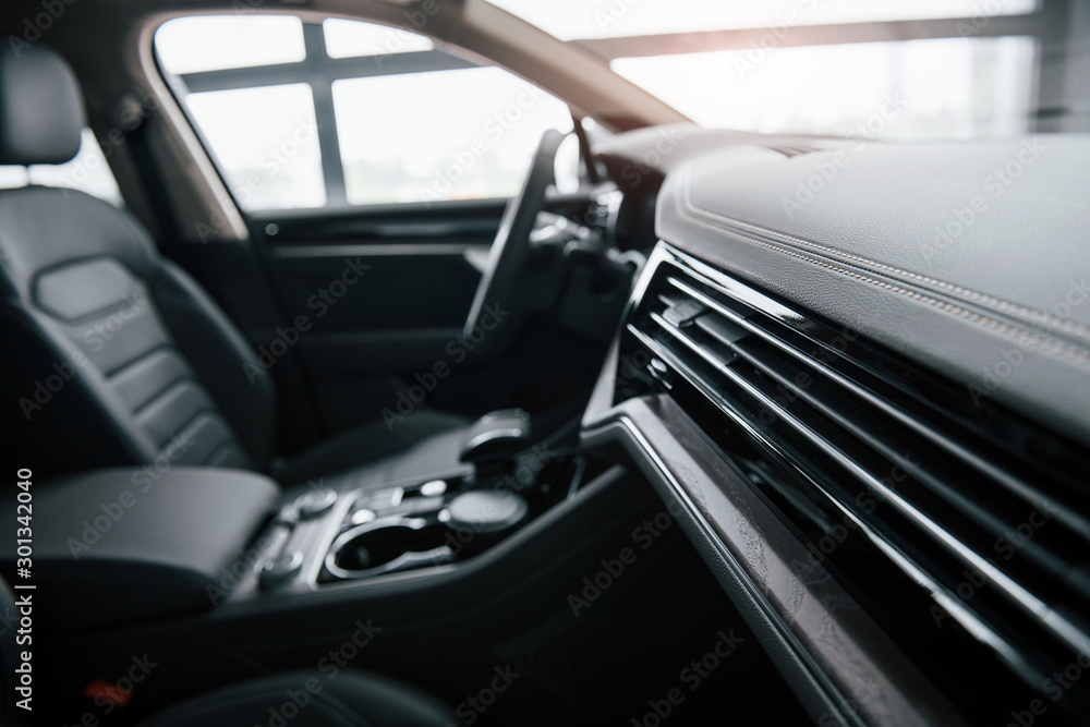 Morning sun. Close up view of interior of brand new modern luxury automobile