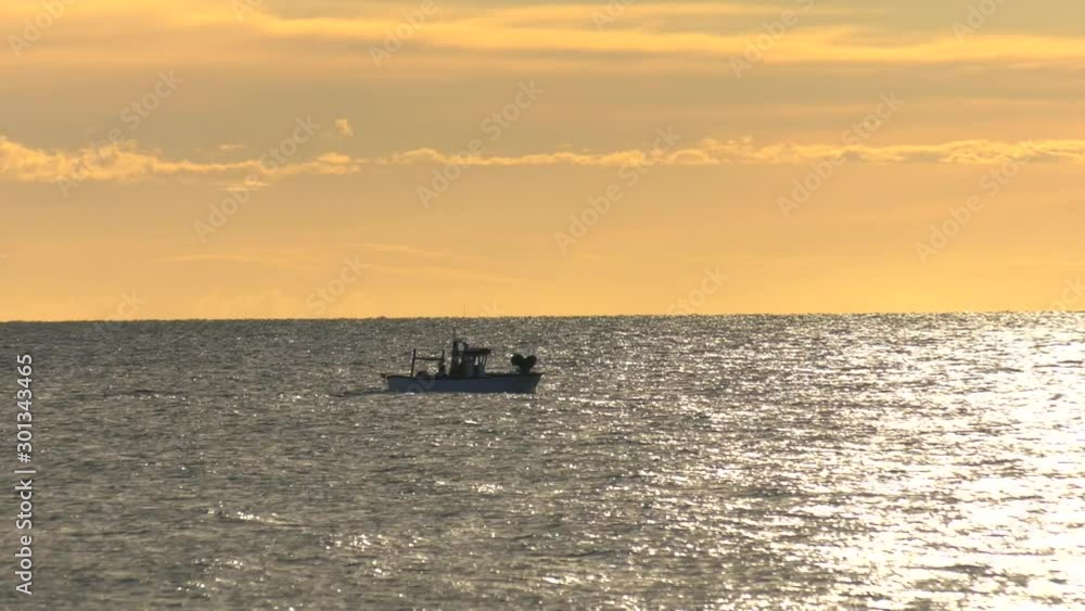 Small Spanish fishing boats on a silver sea at dawn, Mediterranean. Small Spanish fishing boats on a silver sea at dawn, Mediterranean.